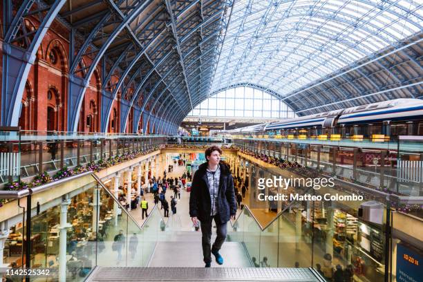 young man at st pancras train station, london, uk - british culture walking stock pictures, royalty-free photos & images