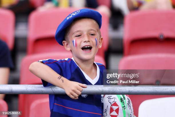Young France supporter cheers on day two of the HSBC Rugby Sevens Singapore at the National Stadium on April 14, 2019 in Singapore.