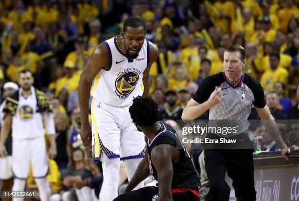 Kevin Durant of the Golden State Warriors has words with Patrick Beverley of the LA Clippers during Game One of the first round of the 2019 NBA...