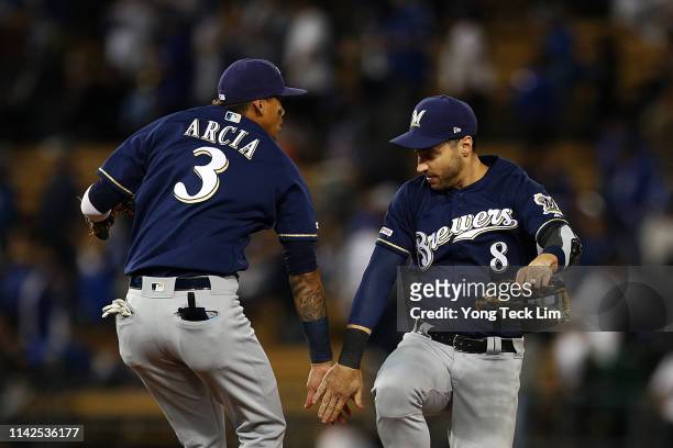Orlando Arcia and Ryan Braun of the Milwaukee Brewers celebrate their 4-1 victory against the Los Angeles Dodgers at Dodger Stadium on April 13, 2019...