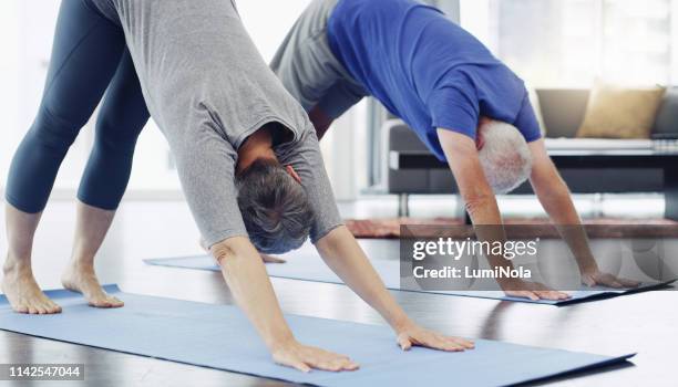 fitness is for any age - downward facing dog position stock pictures, royalty-free photos & images