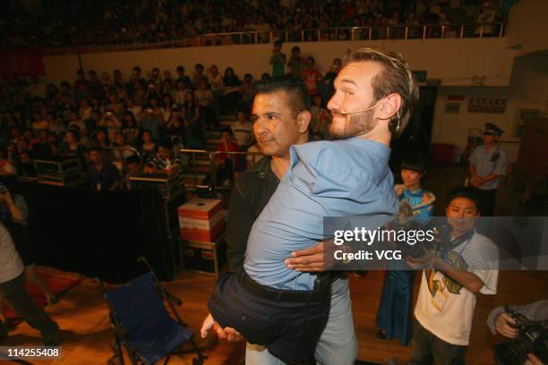 Australian preacher and motivational speaker Nick Vujicic is lifted onto a platform before his public lecture at Zhongnan University of Economics and...