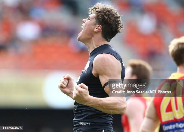 Charlie Curnow of the Blues celebrates his goal during the round four AFL match between the Gold Coast Suns and the Carlton Blues at Metricon Stadium...