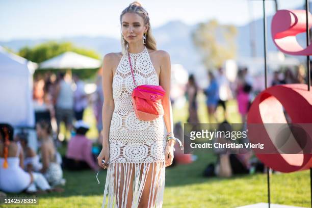 Leonie Hanne is seen wearing white sheer dress with fringes, red bag at the Revolve Festival during Coachella Festival on April 13, 2019 in La...