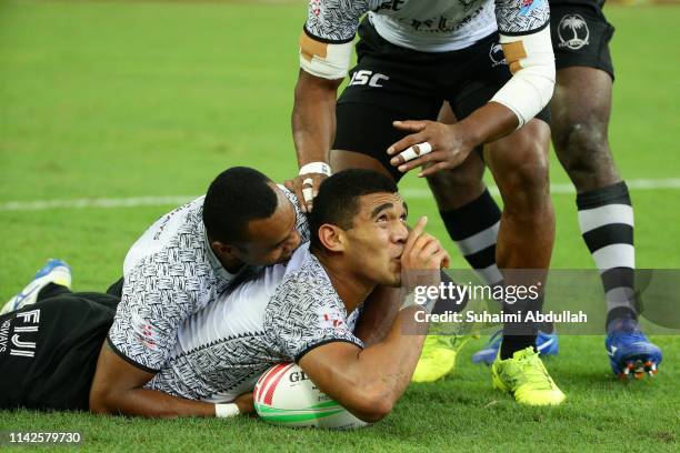 Meli Derenalagi of Fiji celebrates scoring a try during the Cup semi final against Fuji and England on day two of the HSBC Rugby Sevens Singapore at...