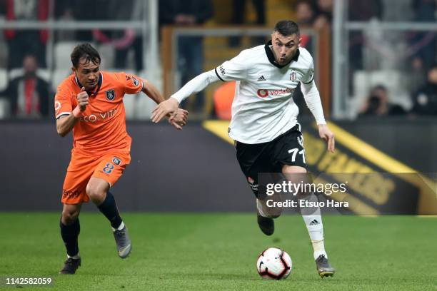 Burak Yilmaz of Besiktas and Jose Marcio Da Costa of Istanbul Basaksehir compete for the ball during the Turkish Super Lig match between Besiktas and...