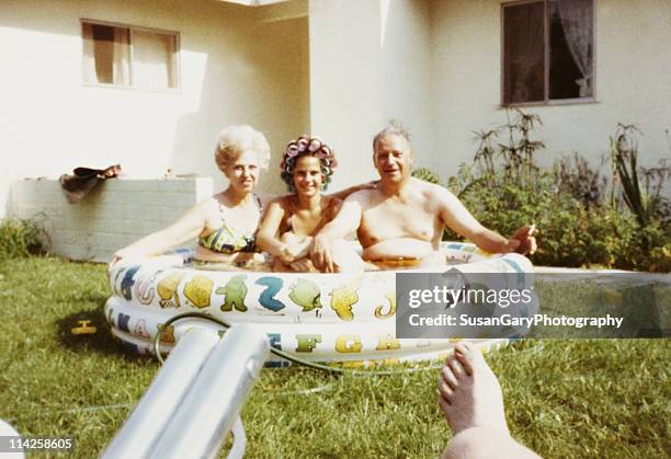 mother, daughter & father in kiddie pool 1971 - women swimming pool retro bildbanksfoton och bilder