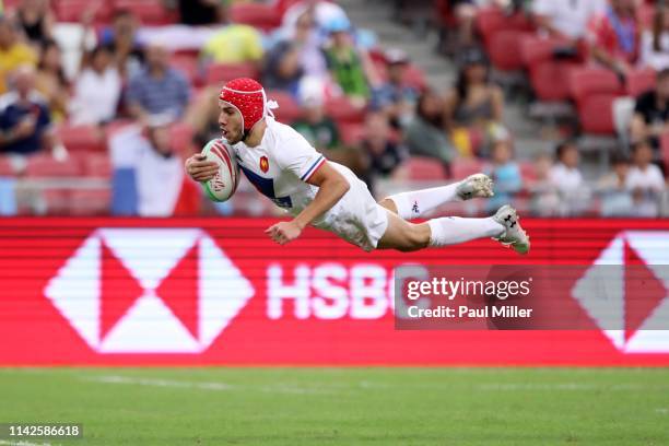 Gabin Villiere of France scores a try during the Challenge Trophy final between Scotland and France on day two of the HSBC Rugby Sevens Singapore at...