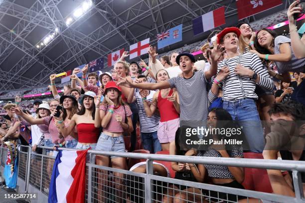 France supporters cheer as France winning the Challenge Trophy on day two of the HSBC Rugby Sevens Singapore at the National Stadium on April 14,...