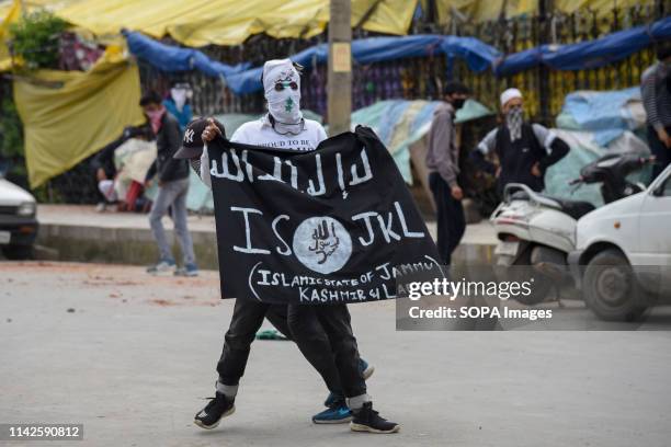 Kashmiri Protester seen holding an ISIS flag during the clashes after Friday prayers in Srinagar. Government forces used tear smoke canisters and...