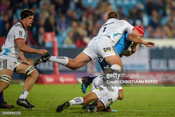 The Vodacom Bulls' South African hooker Schalk Brits is tackled by The Crusaders' New Zealand fullback Richie Mo'unga during the Super XV Rugby Union...