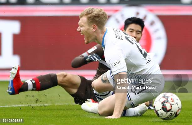 Andreas Voglsammer of Arminia Bielefeld is fouled by Park Yi-Young of FC St. Pauli for a penalty during the Second Bundesliga match between FC St....