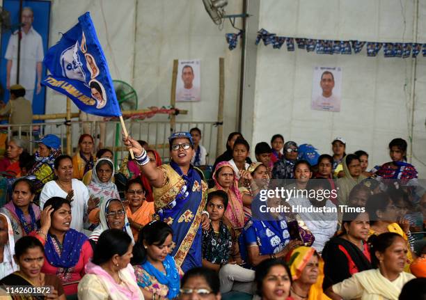 Bahujan Samaj Party supporter waves a party flag during BSP chief Mayawati's public meeting, at Ramlila Maidan, on May 10, 2019 in New Delhi, India.