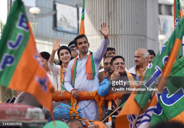 East Delhi candidate for Lok sabha elections Gautam Gambhir and his wife Natasha Jain wave at the crowd during a roadshow ahead of the sixth phase of...