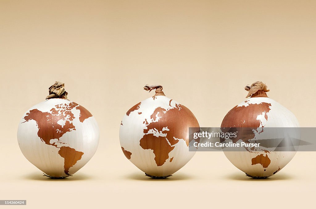 Three onions with map of the world on them