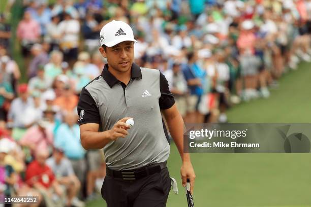 Xander Schauffele of the United States waves on the second green during the final round of the Masters at Augusta National Golf Club on April 14,...