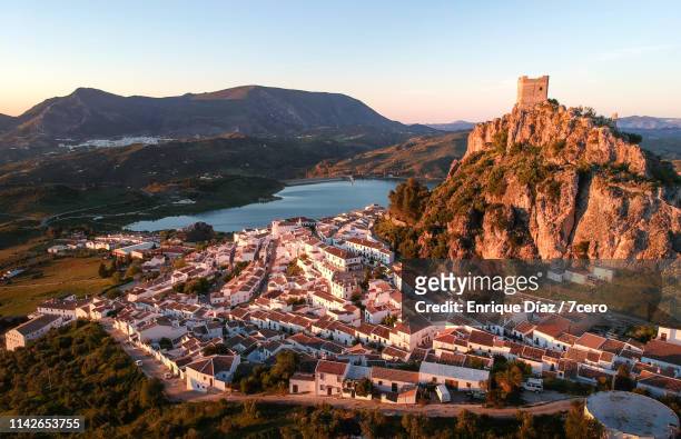pink sunset cast over zahara de la sierra, andalusia, spain - townscape stock pictures, royalty-free photos & images