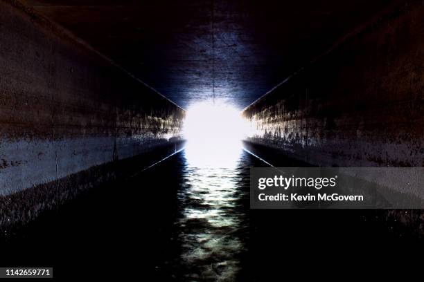 light at the end of the tunnel - dungeon stock pictures, royalty-free photos & images