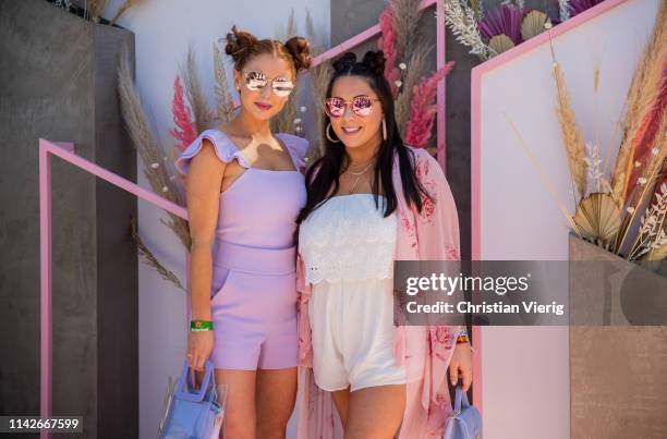 Jackie Oshry wearing pink jumpsuit and Claudia Oshry is seen wearing white jumpsuit, pink kimono at Revolve Festival during Coachella Festival on...