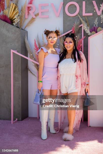 Jackie Oshry wearing pink jumpsuit and Claudia Oshry is seen wearing white jumpsuit, pink kimono at Revolve Festival during Coachella Festival on...