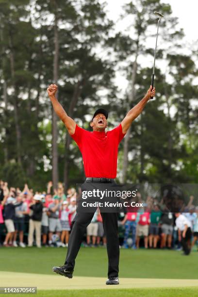 Tiger Woods of the United States celebrates after sinking his putt to win on the 18th green during the final round of the Masters at Augusta National...