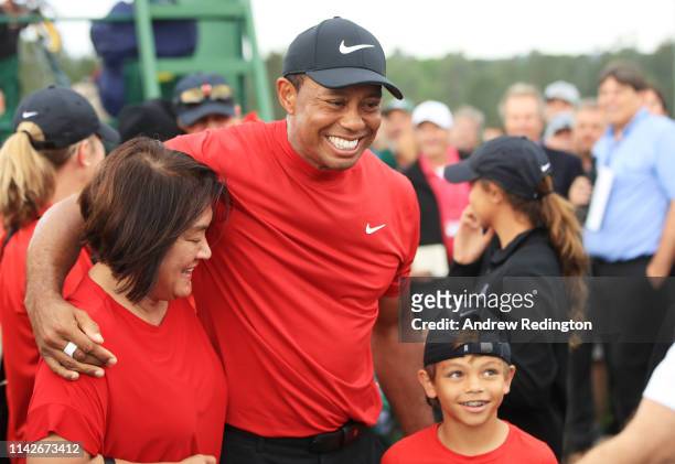 Tiger Woods of the United States celebrates with his son Charlie Axel as he comes off the 18th hole in honor of his win during the final round of the...