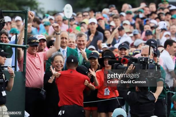 Tiger Woods of the United States celebrates with his son Charlie Axel, his mother Kultida and daughter Sam Alexis as he leaves the 18th green after...