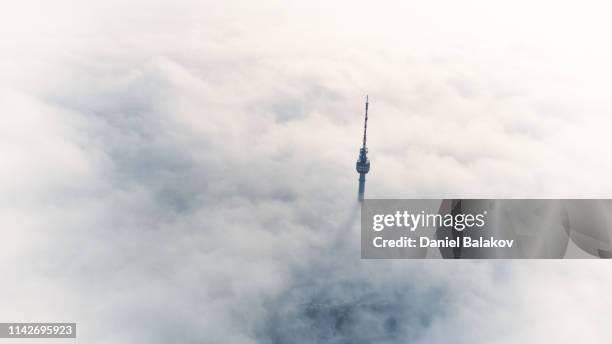 a telecommunications tower over the white sea of clouds. - sea ​​of ​​clouds stock pictures, royalty-free photos & images