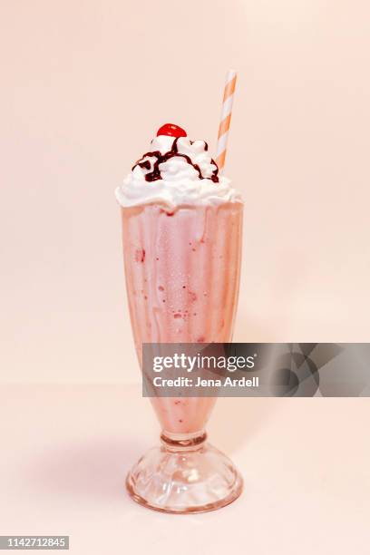strawberry milkshake with whipped cream and cherry on top, retro dessert topping - milkshake stock pictures, royalty-free photos & images