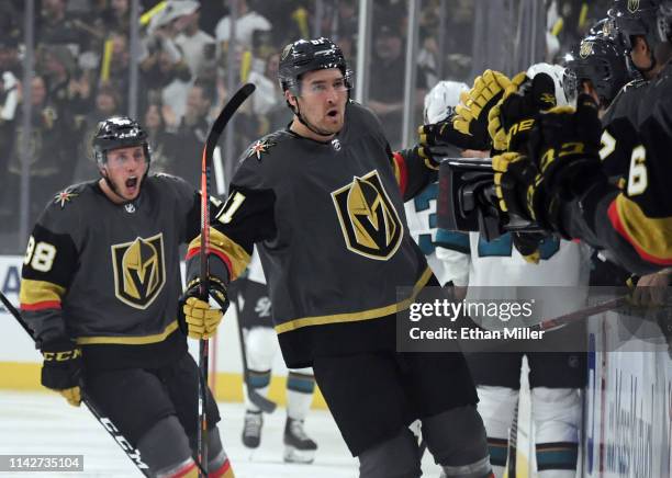 Nate Schmidt and Mark Stone of the Vegas Golden Knights celebrate with teammates on the bench after Schmidt assisted on Stone's first-period goal...