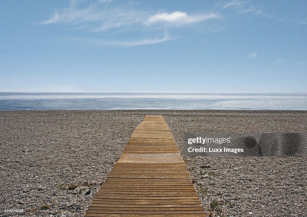 Path on beach leading towards the sea