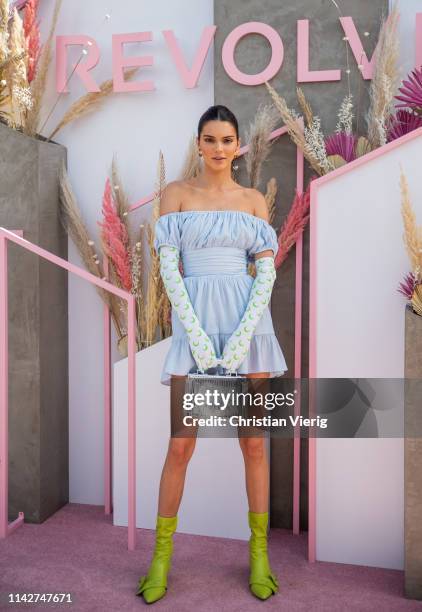 Kendall Jenner is seen wearing blue off shoulder dress, gloves with print, green sock boots at Revolve Festival during Coachella Festival on April...