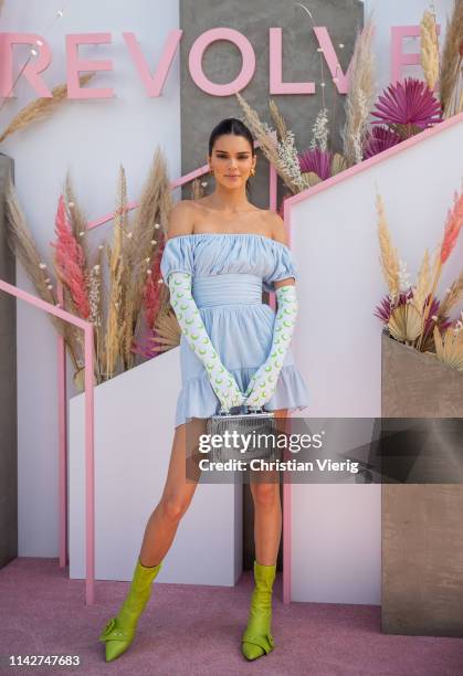 Kendall Jenner is seen wearing blue off shoulder dress, gloves with print, green sock boots at Revolve Festival during Coachella Festival on April...