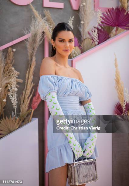Kendall Jenner is seen wearing blue off shoulder dress, gloves with print at Revolve Festival during Coachella Festival on April 14, 2019 in La...