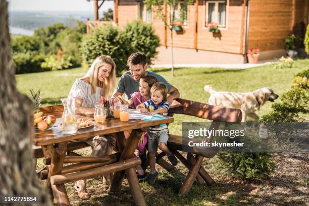 happy family enjoying in coloring at the backyard. - report fun stock pictures, royalty-free photos & images