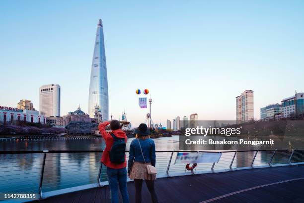 cityscape of seoul downtown city skyline with cherry blossom at sunset - seoul people stock pictures, royalty-free photos & images