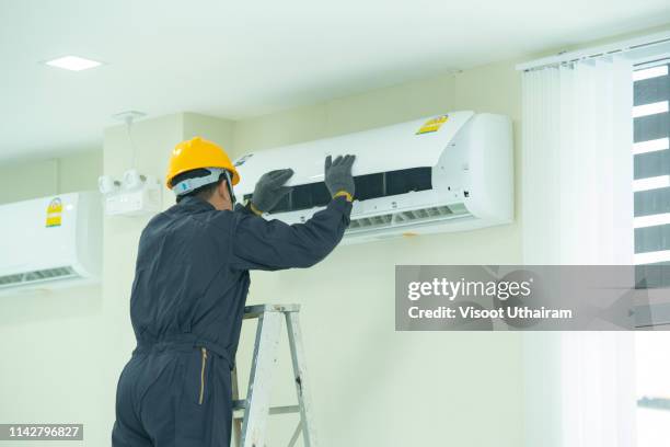 the mechanic technician are repairing technician repairing air conditioner - fridge handle stock pictures, royalty-free photos & images