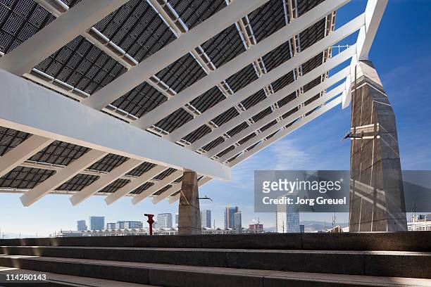 a solar panel and barcelona skyline - solar panel city stock-fotos und bilder