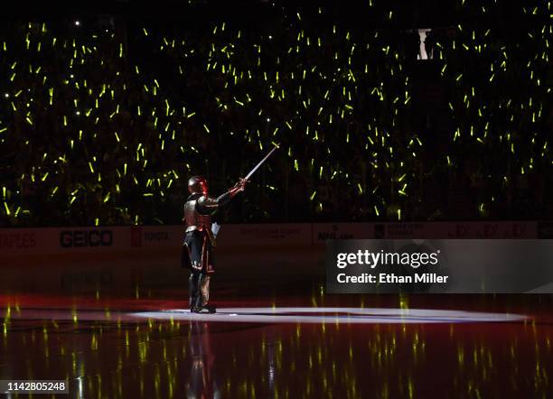 Fans wave glow sticks as Lee Orchard as the Golden Knight performs during a pregame show before Game Three of the Western Conference First Round...