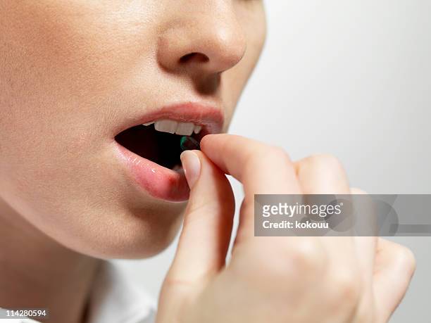 take your medication - woman mouth stock pictures, royalty-free photos & images