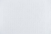 top view of text Lorem ipsum in international braille code on white paper