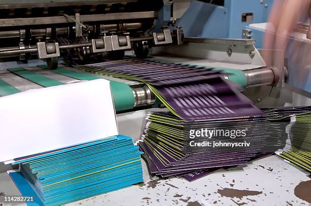 folding machine in motion... - bonding stock pictures, royalty-free photos & images