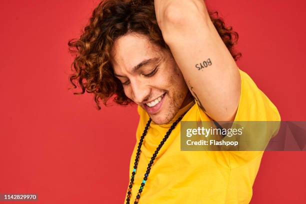 colourful studio portrait of a young man - one man only stock pictures, royalty-free photos & images