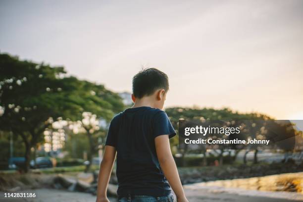 young boy view from the back - kota kinabalu beach stock pictures, royalty-free photos & images