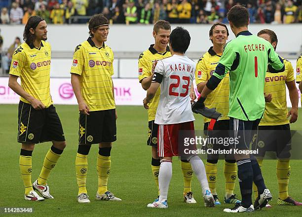 Lukasz Piszczek of Dortmund welcomes Shinji Kagawa of Japan prior to the charity match between Borussia Dortmund and a Team of Japan at the...