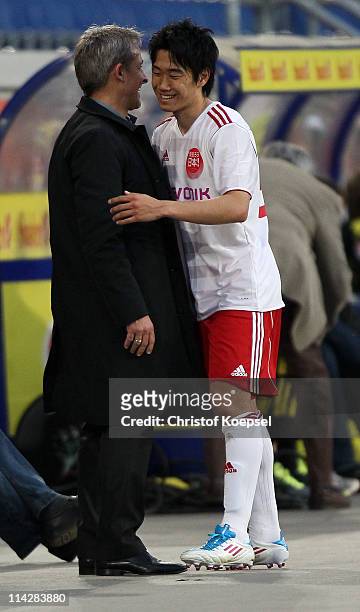 Coach Pierre Littbarski of Japan and Shinji Kagawa of Japan embrace during the charity match between Borussia Dortmund and a Team of Japan at the...