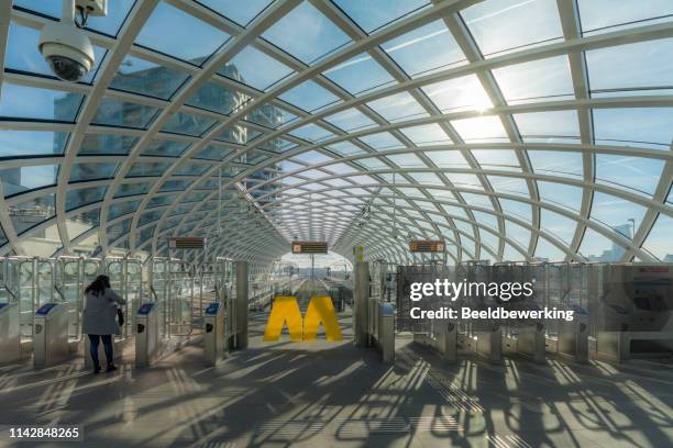 woman takes new metroline part of randstad rail - rotterdam station stock pictures, royalty-free photos & images