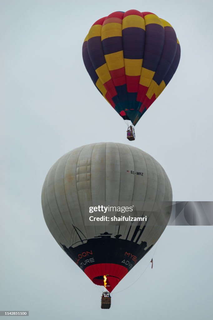 Cloudy morning view with hot balloons over lake Putrajaya, Malaysia.