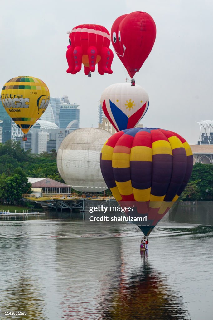 Cloudy morning view with hot balloons over lake Putrajaya, Malaysia.