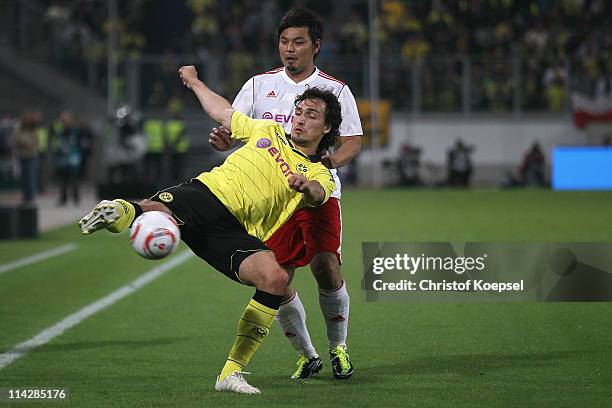 Shoji Jo of Japan challenges Mats Hummels of Dortmund during the charity match between Borussia Dortmund and a Team of Japan at the Schauinsland...